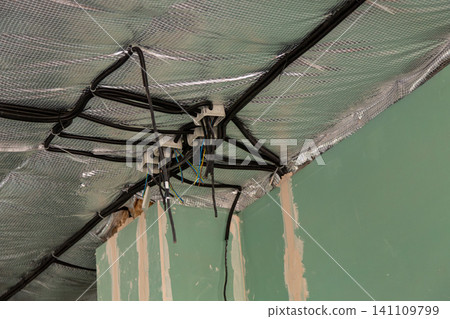 Electrical cable installation above insulated ceiling during house construction Electrical cable installation above insulated ceiling during house construction 141109799