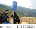 Happy couple enjoying scenic mountain view with prayer flag at Tinchuley in Darjeeling 141110821