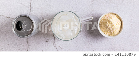 Carbonated protein drink in a glass and a can on the table top view web banner Carbonated protein drink in a glass and a can on the table top view web banner 141110879