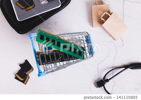 Two computer memory modules in a shopping cart on a table top view Two computer memory modules in a shopping cart on a table top view 141110885