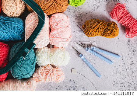 Close up of a set of colored yarn and tools for carpet embroidery on a table top view 141111017