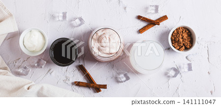 Delicious trendy protein coffee with yogurt in a glass on the table top view web banner Delicious trendy protein coffee with yogurt in a glass on the table top view web banner 141111047
