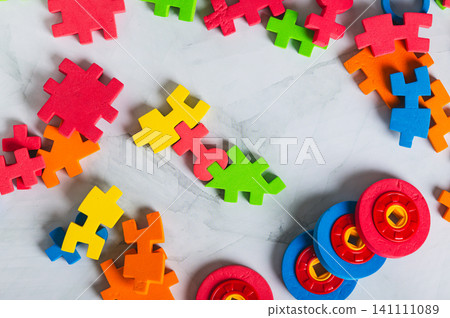 Colorful puzzle pieces for children's tabletop game top view Colorful puzzle pieces for children's tabletop game top view 141111089