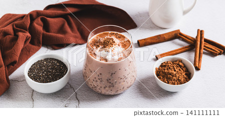 Overnight oats with chia seeds and cinnamon in a glass on the table web banner Overnight oats with chia seeds and cinnamon in a glass on the table web banner 141111111
