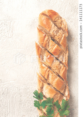 garlic bread,baguette with garlic butter and herbs, on a light table, top view, garlic bread,baguette with garlic butter and herbs, on a light table, top view, 141111173