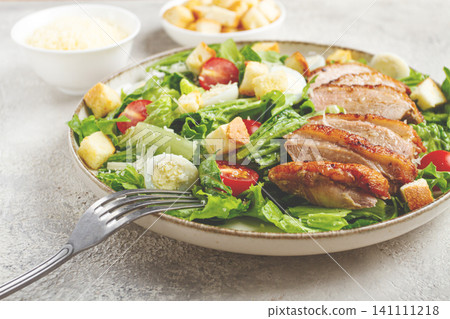 Caesar salad, with duck breast, on a light plate, on a light background, homemade, no people, Caesar salad, with duck breast, on a light plate, on a light background, homemade, no people, 141111218