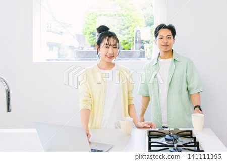 A couple having breakfast in the kitchen: Minimalist lifestyle A couple having breakfast in the kitchen: Minimalist lifestyle 141111395