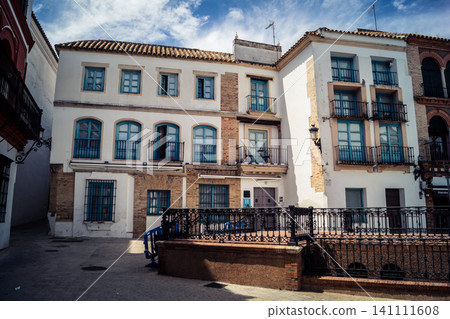 Traditional white-washed narrow streets and historical Andalusian architecture in Carmona Traditional white-washed narrow streets and historical Andalusian architecture in Carmona 141111608