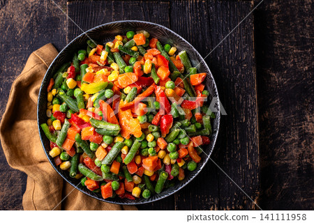 Frozen mix of vegetables on dark background Frozen mix of vegetables on dark background 141111958