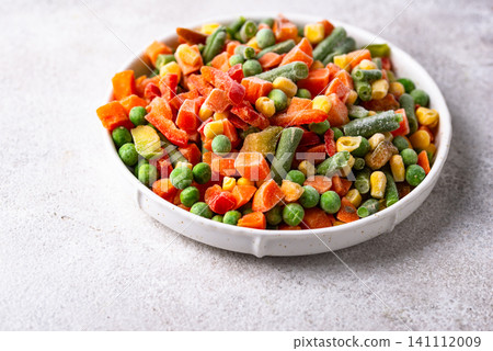 Frozen mix of vegetables on dark background Frozen mix of vegetables on dark background 141112009