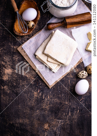 Raw puff pastry dough with baking ingredient Raw puff pastry dough with baking ingredient 141112080