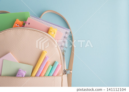 Backpack organized with pastel school supplies for education concept Backpack organized with pastel school supplies for education concept 141112104