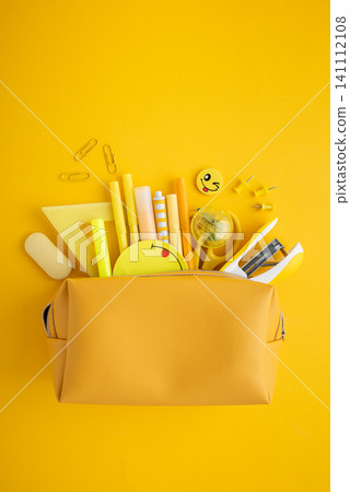 Yellow pencil case overflowing with school supplies back to school Yellow pencil case overflowing with school supplies back to school 141112108