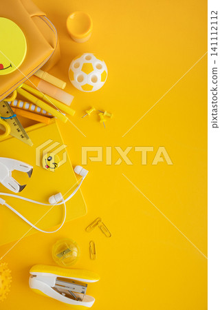 Back to school supplies flat lay on yellow background Back to school supplies flat lay on yellow background 141112112