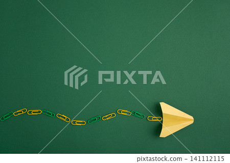 Paper plane leading a chain of paper clips Paper plane leading a chain of paper clips 141112115