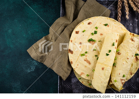 Lavash flat bread on green background Lavash flat bread on green background 141112159