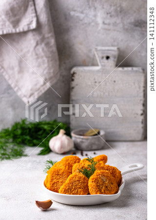 Raw uncooked frozen chicken nuggets Raw uncooked frozen chicken nuggets 141112348