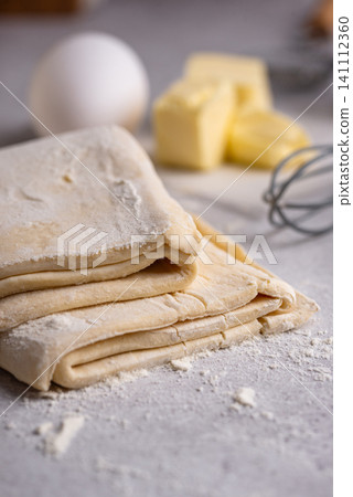 Raw puff pastry dough with baking ingredient Raw puff pastry dough with baking ingredient 141112360
