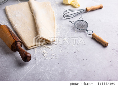 Raw puff pastry dough with baking ingredient Raw puff pastry dough with baking ingredient 141112369