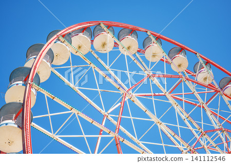 Close up Ferris Wheel Against Blue Sky Close up Ferris Wheel Against Blue Sky 141112546