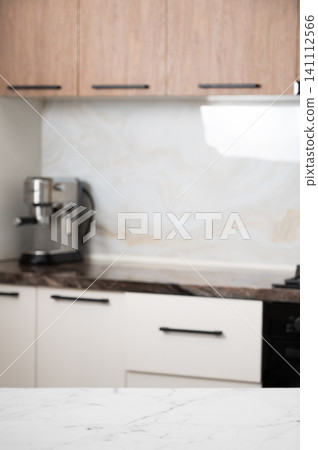 A bright kitchen with a stovetop, stone countertop, and coffee machine in a minimalist style A bright kitchen with a stovetop, stone countertop, and coffee machine in a minimalist style 141112566