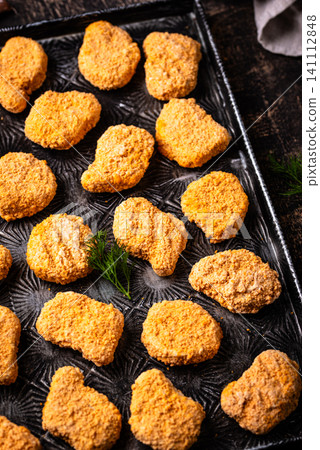 Raw uncooked frozen chicken nuggets Raw uncooked frozen chicken nuggets 141112848