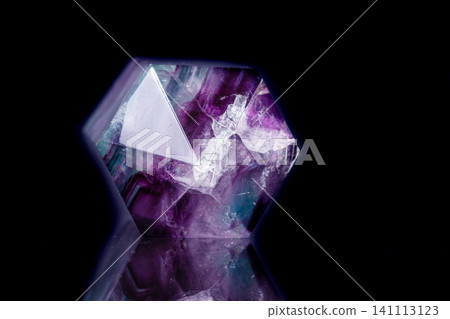 Macro mineral stone Fluorite crystal on a black background Macro mineral stone Fluorite crystal on a black background 141113123
