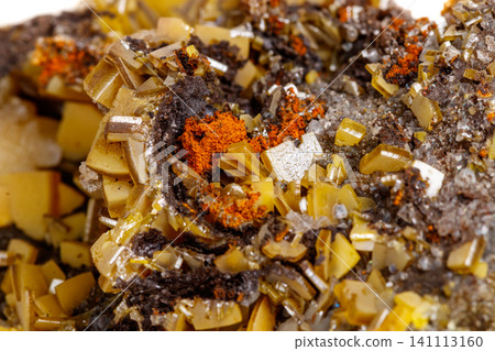 Macro mineral stone yellow Wulfenite on a white background Macro mineral stone yellow Wulfenite on a white background 141113160