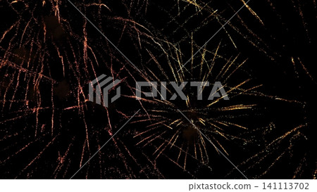 Golden and pink fireworks burst across dark night sky, sending sparkling trails and radiant flashes through festive celebration atmosphere, creating vivid brilliance, motion, and Golden and pink fireworks burst across dark night sky, sending sparkling trails and radiant flashes through festive celebration atmosphere, creating vivid brilliance, motion, and 141113702