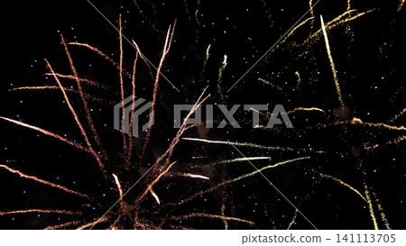 Bright fireworks burst across dark night sky with long sparkling trails in gold, pink, white, and blue, creating festive celebration atmosphere and dramatic glowing light Bright fireworks burst across dark night sky with long sparkling trails in gold, pink, white, and blue, creating festive celebration atmosphere and dramatic glowing light 141113705
