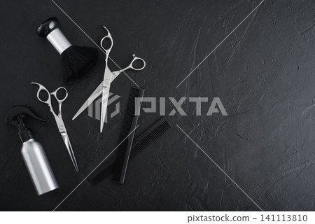 Professional hairdresser tools on a black textured concrete background. Professional hairdresser tools on a black textured concrete background. 141113810