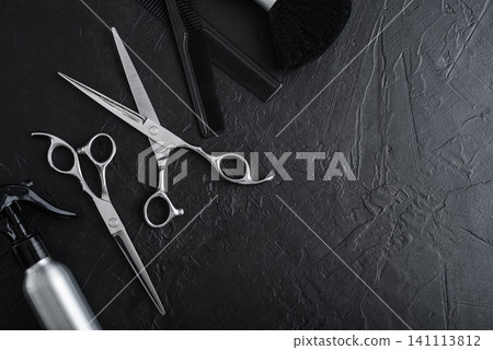 Professional hairdresser tools on a black textured concrete background. Professional hairdresser tools on a black textured concrete background. 141113812