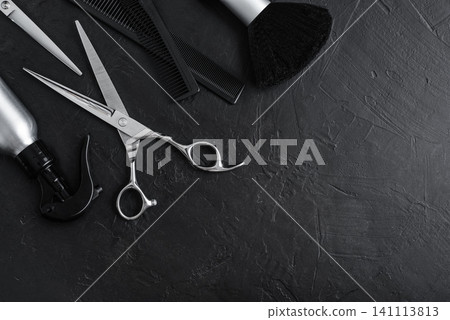 Professional hairdresser tools on a black textured concrete background. Professional hairdresser tools on a black textured concrete background. 141113813