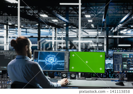 Server room engineer working with chroma key computer to run AI prediction simulations, tracking performance. Server room engineer working with chroma key computer to run AI prediction simulations, tracking performance. 141113858