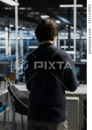 System administrator uses a computer in a data center to deploy software updates, configure hardware, and support reliable operations. System administrator uses a computer in a data center to deploy software updates, configure hardware, and support reliable operations. 141114003