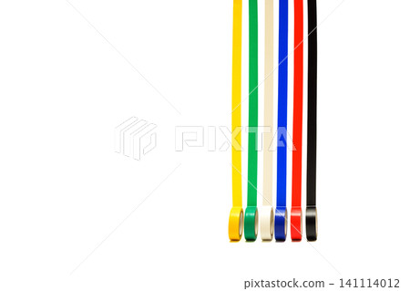 six thin multicolored lines of unrolled electrical tape go upwards from vertically standing spools six thin multicolored lines of unrolled electrical tape go upwards from vertically standing spools 141114012