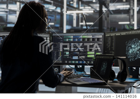 Server room software developer reviews AI visual analytics dashboard to pinpoint equipment performance problems. 141114016