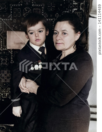 Grandmother Holding a Young Boy in Soviet Military Style Uniform in Dnipropetrovsk, Ukraine, September 1971 Grandmother Holding a Young Boy in Soviet Military Style Uniform in Dnipropetrovsk, Ukraine, September 1971 141114489