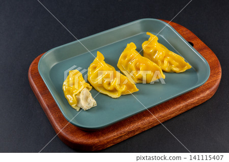 steamed Yellow Pumpkin Dumplings on White Plate, Healthy Chinese Jiaozi steamed Yellow Pumpkin Dumplings on White Plate, Healthy Chinese Jiaozi 141115407