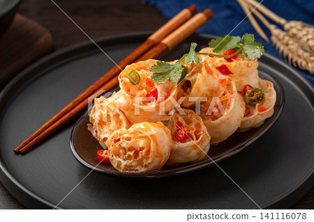 chinese cold dish spicy wheat gluten salad with chili oil and coriander in a grey ceramic pot 141116078