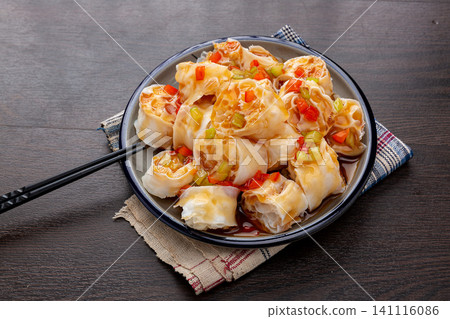 refreshing cold wheat gluten salad with garlic and chili sauce on a dark wooden table refreshing cold wheat gluten salad with garlic and chili sauce on a dark wooden table 141116086