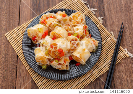 refreshing cold wheat gluten salad with garlic and chili sauce on a dark wooden table refreshing cold wheat gluten salad with garlic and chili sauce on a dark wooden table 141116090