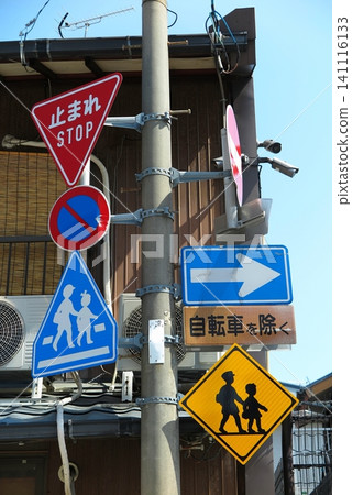 Road signs (vertical orientation) erected along the side of a road designated as a school zone. Road signs (vertical orientation) erected along the side of a road designated as a school zone. 141116133
