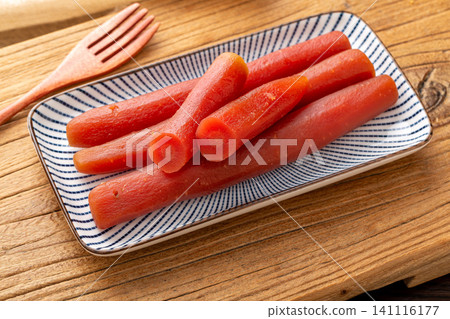 traditional Chinese pickled carrot sticks served on a rectangular plate, savory vegan side dish traditional Chinese pickled carrot sticks served on a rectangular plate, savory vegan side dish 141116177