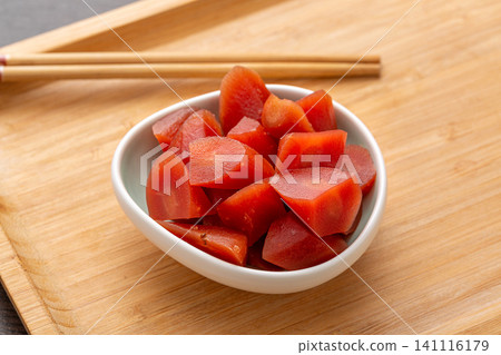 savory pickled carrot chunks in a white ceramic bowl on a wooden tray, Asian style marinated vegetable savory pickled carrot chunks in a white ceramic bowl on a wooden tray, Asian style marinated vegetable 141116179