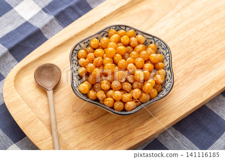 bowl of fried crispy golden soybeans, crunchy savory Asian snack served on a rustic wooden tray bowl of fried crispy golden soybeans, crunchy savory Asian snack served on a rustic wooden tray 141116185