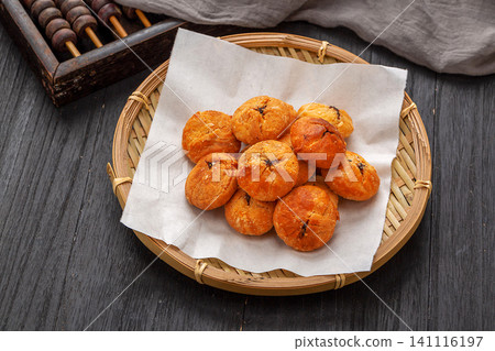 authentic Huizhou Huangshan baked flaky biscuits served in a bamboo basket with vintage abacus authentic Huizhou Huangshan baked flaky biscuits served in a bamboo basket with vintage abacus 141116197