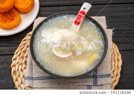 traditional Chinese Egg Noodle Soup in Ceramic Bowl, Rustic Style Asian Comfort Food traditional Chinese Egg Noodle Soup in Ceramic Bowl, Rustic Style Asian Comfort Food 141116206