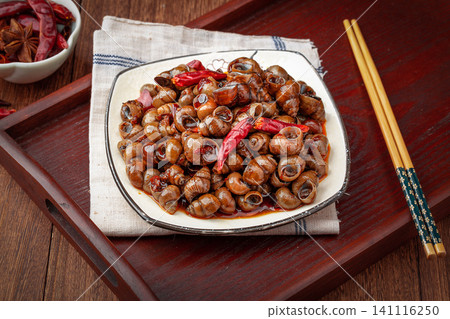 spicy stir-fried river snails with chili peppers on a plate, traditional Chinese street food, Asian culinary cuisine. spicy stir-fried river snails with chili peppers on a plate, traditional Chinese street food, Asian culinary cuisine. 141116250