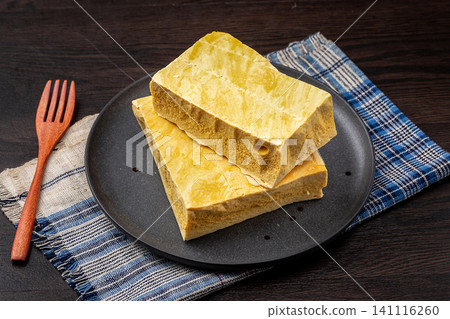 Handmade crispy honeycomb candy blocks on a black ceramic plate Handmade crispy honeycomb candy blocks on a black ceramic plate 141116260